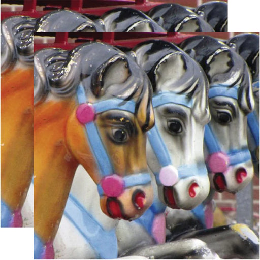 Close-up of colorful horse heads on a carousel paper napkin.