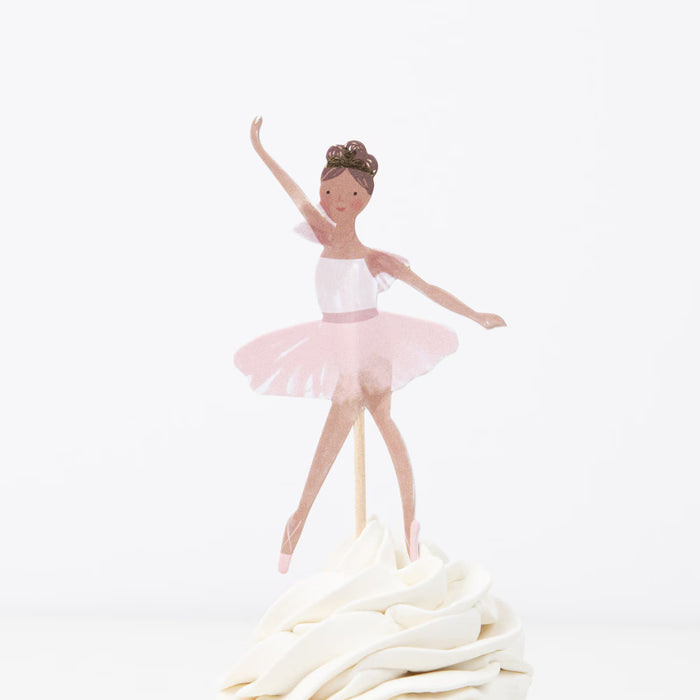 Ballerina figurine on a cake with white frosting