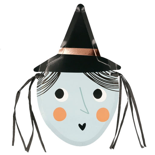 A die-cut paper plate designed to look like a witch's face with a black hat, copper foil detail, and black raffia hair.