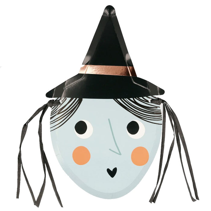 A die-cut paper plate designed to look like a witch's face with a black hat, copper foil detail, and black raffia hair.