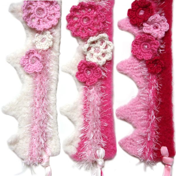 Pink and cream princess crochet wool crown with floral details and ribbon ties for little girls