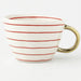 White mug with red stripes and a gold handle on a white background