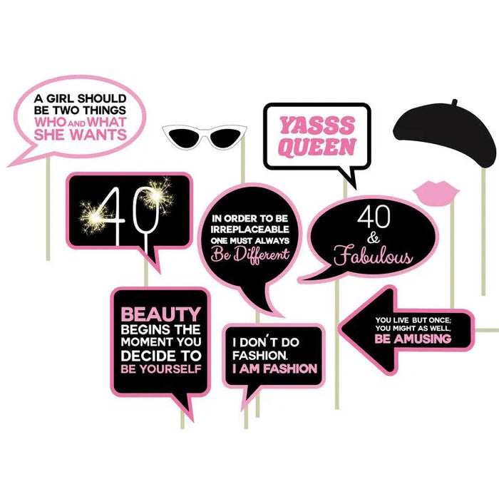 A collection of photo props for a 40th birthday party, including signs with phrases such as '40 & Fabulous' and various other celebratory statements, along with accessories like a beret, sunglasses, and lips.