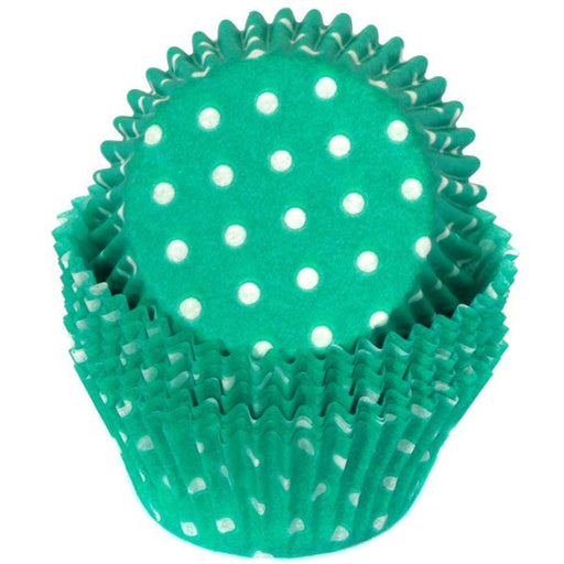 A teal green baking cup with white polka dots.