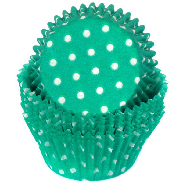 A teal green baking cup with white polka dots.