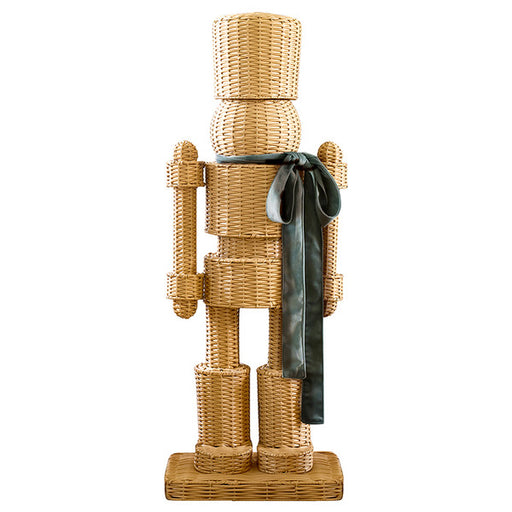 All-weather rattan wicker nutcracker with green satin ribbon — a coastal and preppy Christmas holiday decoration for indoor and outdoor display