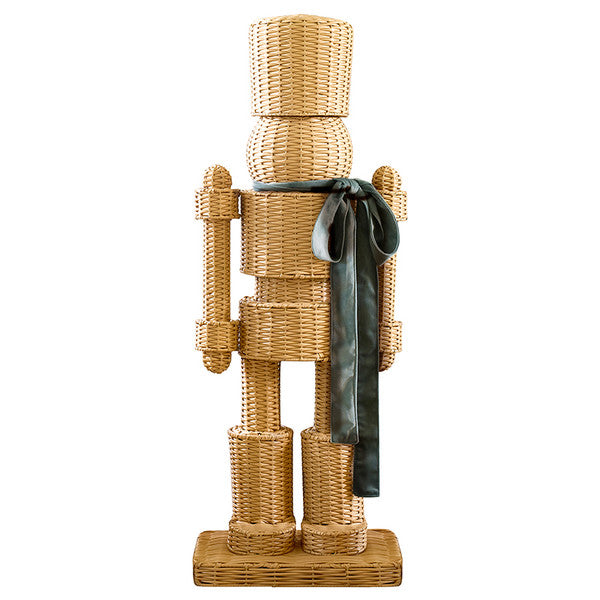 All-weather rattan wicker nutcracker with green satin ribbon — a coastal and preppy Christmas holiday decoration for indoor and outdoor display