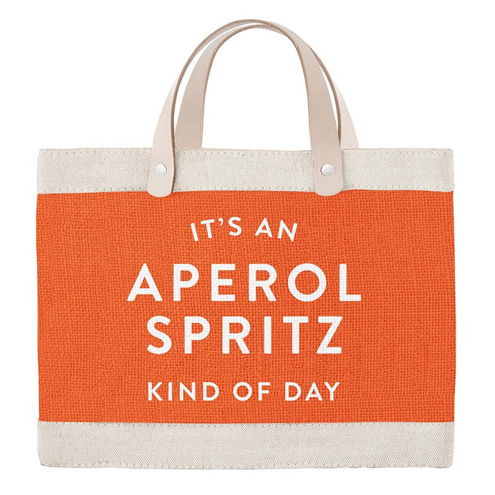 Orange tote bag with white text 'It's an Aperol Spritz kind of day' on a white background