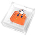 Orange handbag weight on an acrylic napkin holder