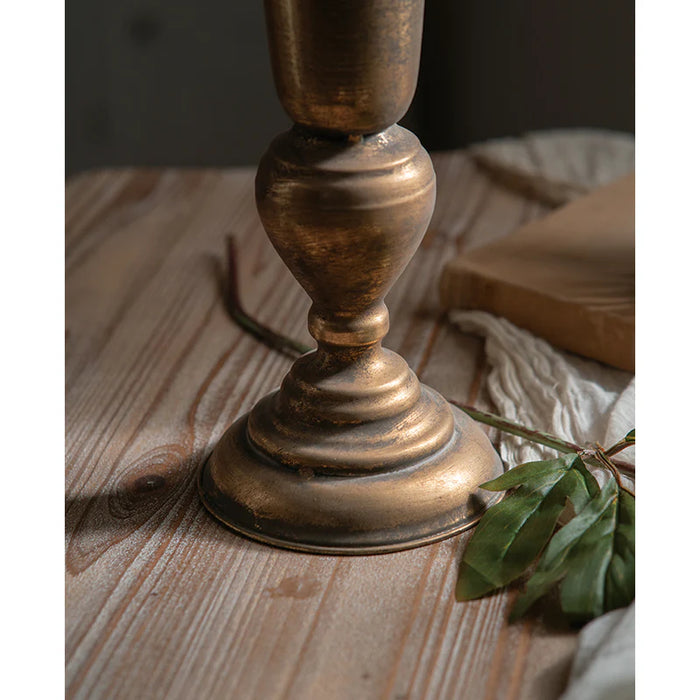 Gold vase on a wooden surface with a soft focus background