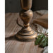 Gold vase on a wooden surface with a soft focus background