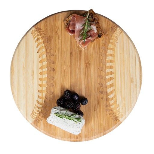 Wooden cutting board with prosciutto, blackberries, and goat cheese on a white background