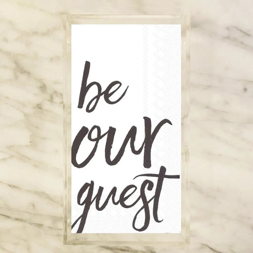 White paper guest towels printed with "be our guest" in black script calligraphy — elegant bathroom and powder room entertaining accessory for parties, weddings, and holiday hosting
