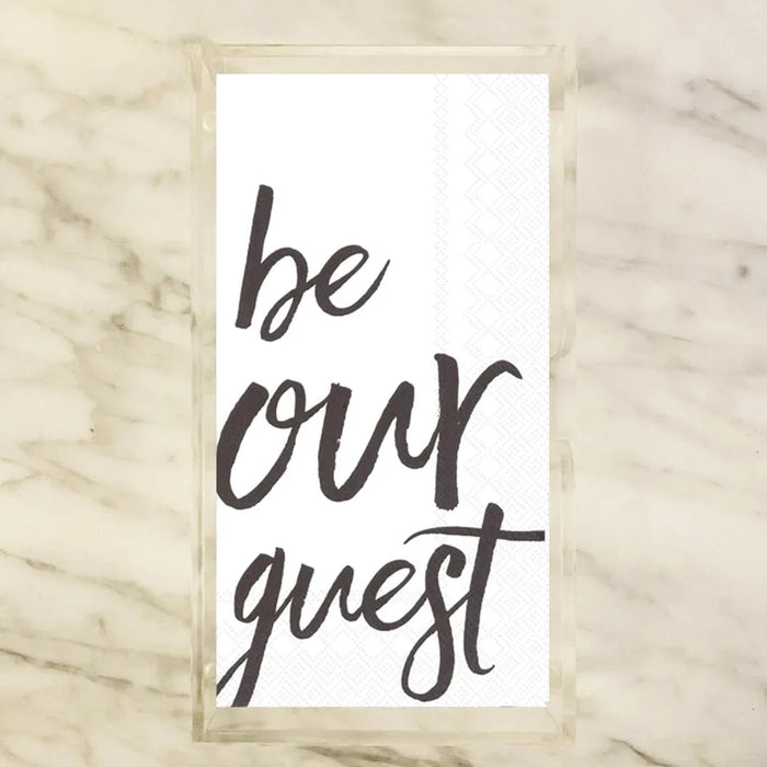 White paper guest towels printed with "be our guest" in black script calligraphy — elegant bathroom and powder room entertaining accessory for parties, weddings, and holiday hosting