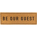 Doormat with 'Be Our Guest' text on a white background