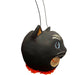 A black cat-shaped paper mâché bucket, hand-painted blue eyes, white whiskers and markings, an orange mouth, and a bright orange ruffled trim at the bottom.