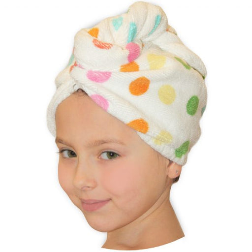 A child with a white hair turban with multicolored polka dots.