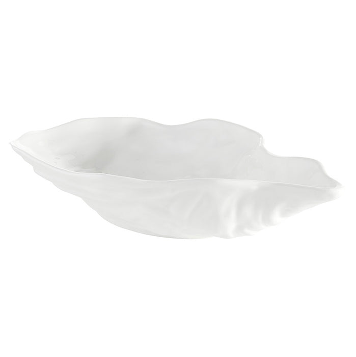 White ceramic bowl with a wavy edge on a white background