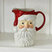 A ceramic Santa Claus pitcher with a red handle and spout.