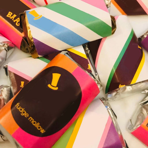 A collection of colorful chocolate factory food tent wrappers with the brand name 'Wonka' displayed prominently.