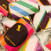 A collection of colorful chocolate factory food tent wrappers with the brand name 'Wonka' displayed prominently.