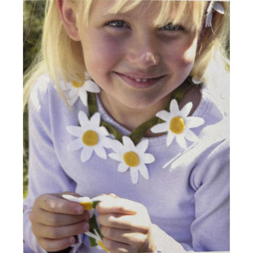 Child wearing a floral necklace with daisies in an outdoor setting