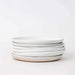 Stack of white ceramic plates on a white background