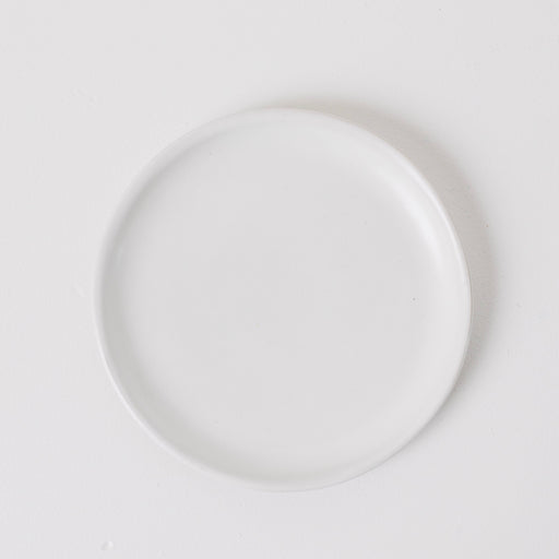 White ceramic plate on a light gray background