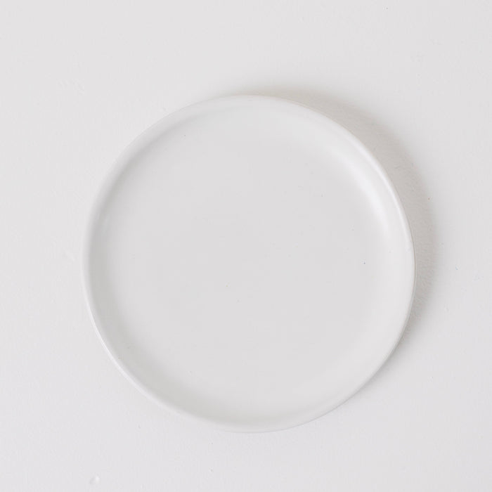 White ceramic plate on a light gray background