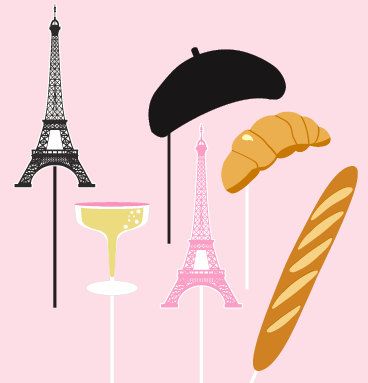 A set of props including a black beret, a pink Eiffel Tower, a yellow champagne glass, a croissant, and a long bread stick, meant for fashion photo shoots with a Paris theme.