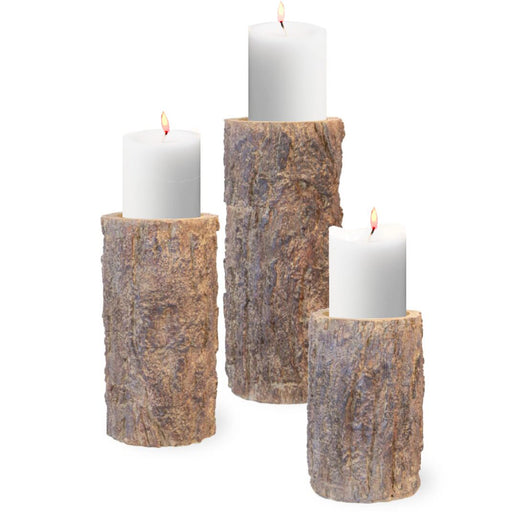 A set of three pine pillar candle holders in varying heights, designed to look like cut sections of a pine log.