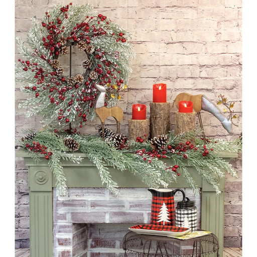 Set of 3 rustic pine log candle holders made of sculpted resin on a holiday mantel