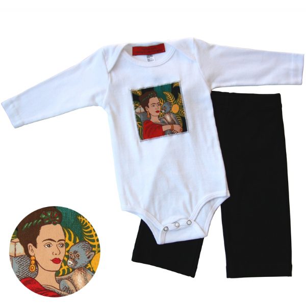 A baby onesie with a Frida Kahlo patch on the front and a pair of black karate pants laid out next to it.