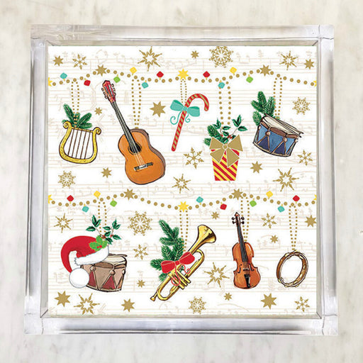 Christmas-themed napkins featuring musical instruments like guitar, violin, trumpet, drums, and lyre, adorned with holiday elements like Santa hats, gifts, candy canes, holly, snowflakes, and gold stars on a musical note background.