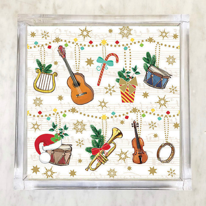 Christmas-themed napkins featuring musical instruments like guitar, violin, trumpet, drums, and lyre, adorned with holiday elements like Santa hats, gifts, candy canes, holly, snowflakes, and gold stars on a musical note background.