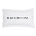 A white rectangular decorative pillow with fringed edges featuring the phrase 'We Are Beach People' in charcoal grey text.
