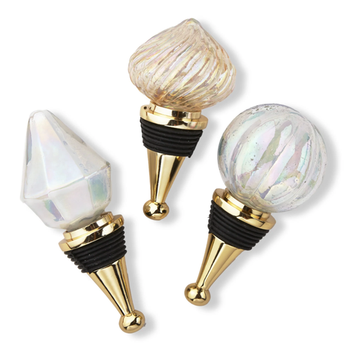 Three decorative bottle stoppers with gold and black accents on a white background