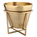 Gold metal planter with decorative stand on a white background