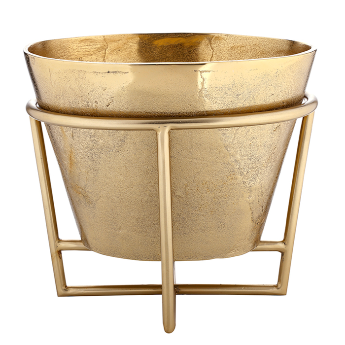 Gold metal planter with decorative stand on a white background