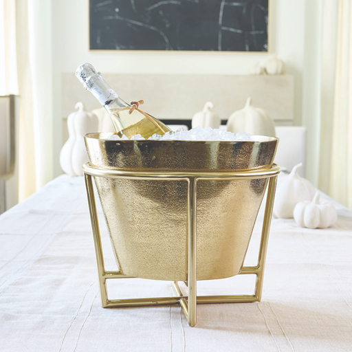 Gold aluminum champagne and wine bucket on stand styled in elegant party setting
