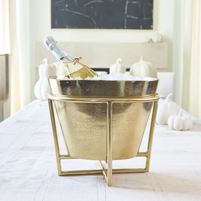Gold aluminum champagne and wine bucket on stand styled in elegant party setting