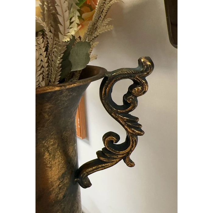 Decorative metal vase with intricate design on a white background