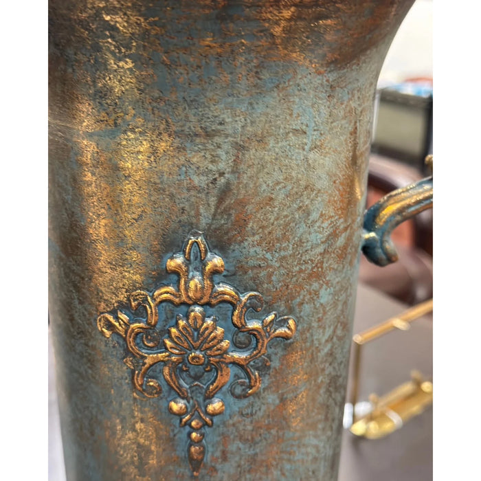 Decorative brass ornament on a metal surface with a blurred background