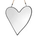 Heart-shaped mirror with black frame hanging on a white background