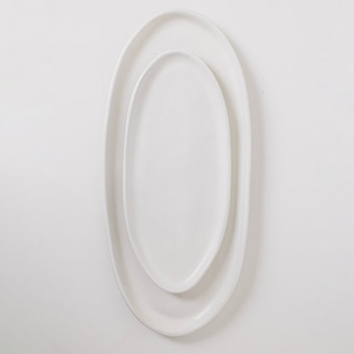White oval mirror on a light gray background