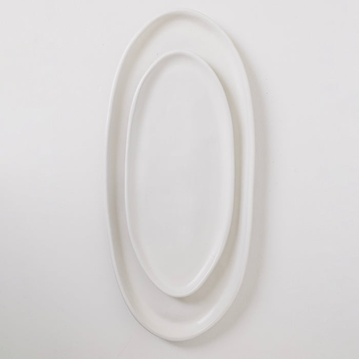 White oval mirror on a light gray background