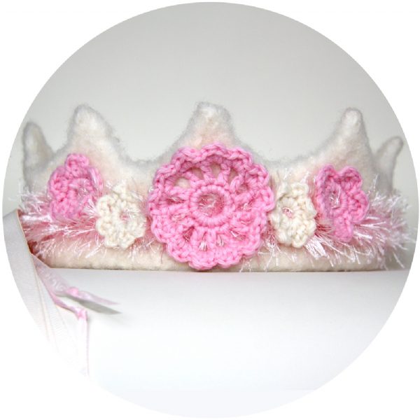 Pink and cream princess crochet wool crown with floral details and ribbon ties for little girls