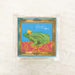 Kiss Me Frog Cocktail Napkin featuring a crowned frog design on a blue background