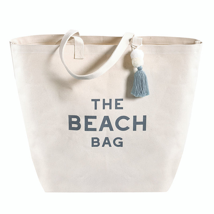 Large canvas beach tote bag with leather handles and tassel detail, THE BEACH BAG lettering
