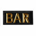 Decorative sign with 'BAR' in gold letters on a black background